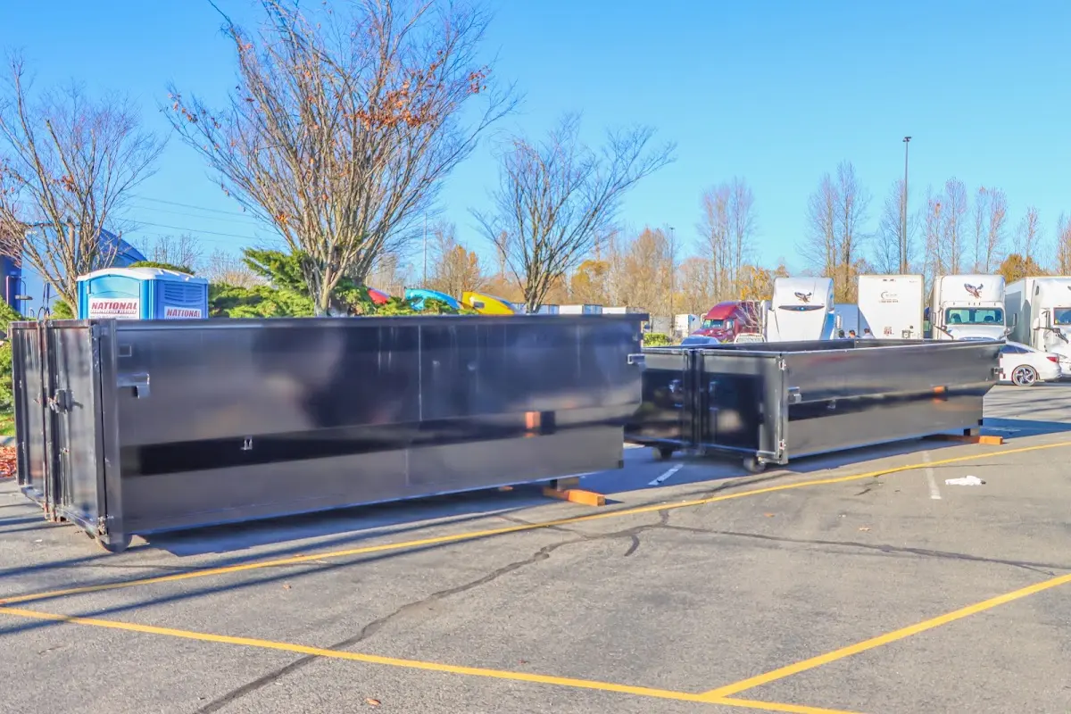 Professional dumpster rental service with roll-off container on residential driveway in Lindstrom